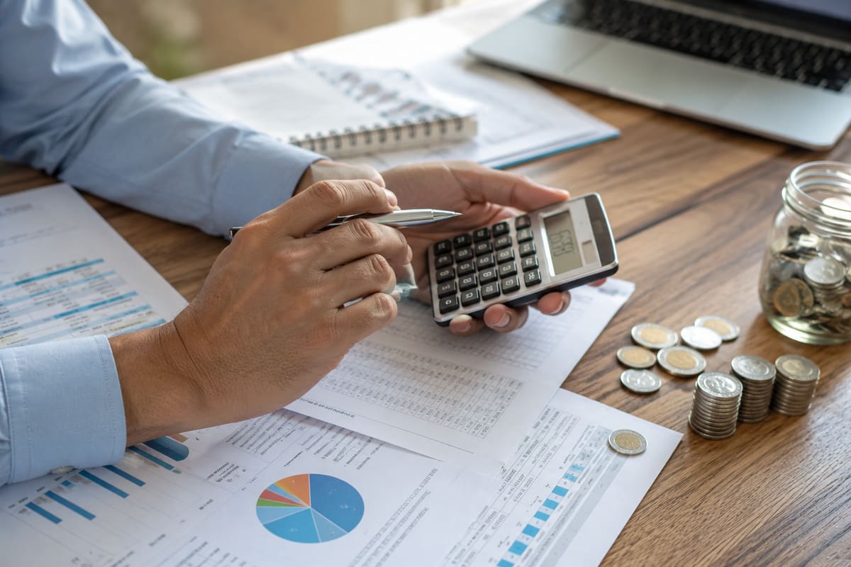 Comparing ADU financing options with paperwork and calculator at a desk
